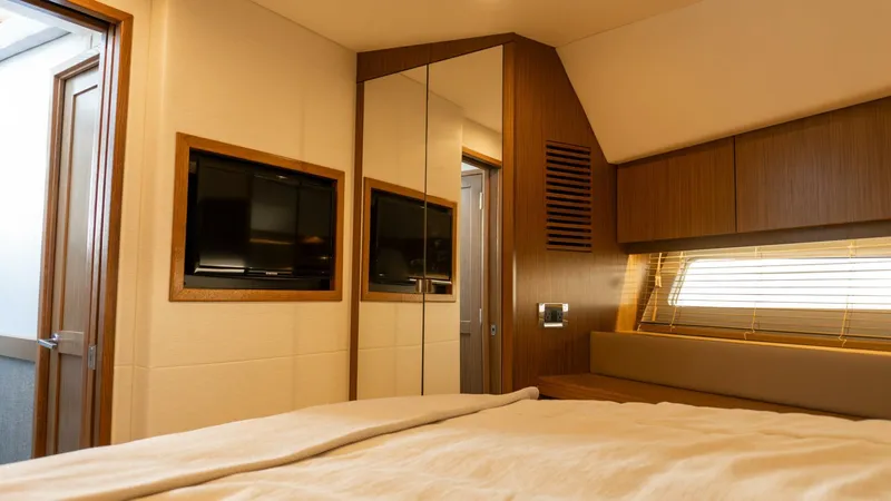 O-sea-d Yacht Photos Pics Luxurious cabin interior of 2017 Sea Ray 51 Flybridge yacht with TV and wood accents.