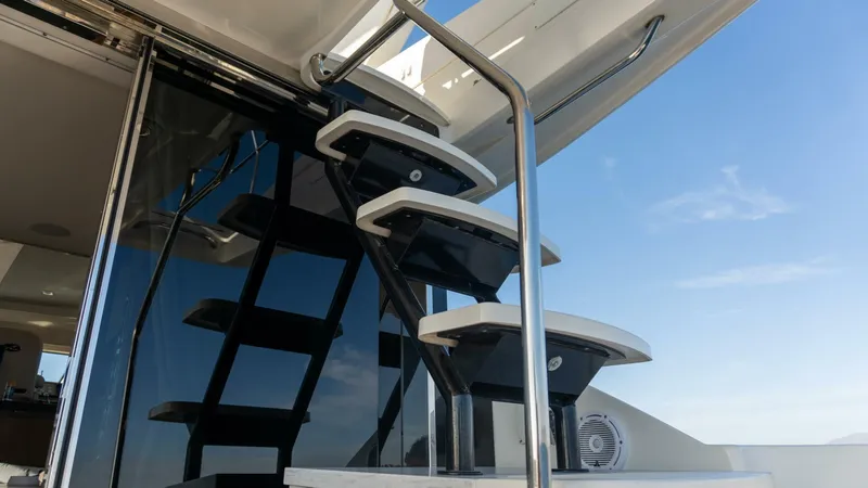 O-sea-d Yacht Photos Pics Staircase on 2017 Sea Ray 51 Flybridge yacht against clear blue sky.