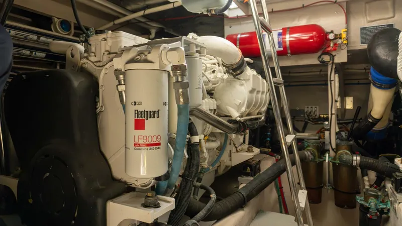 O-sea-d Yacht Photos Pics Engine room of 2017 Sea Ray 51 Flybridge yacht, featuring mechanical components and fire extinguisher.
