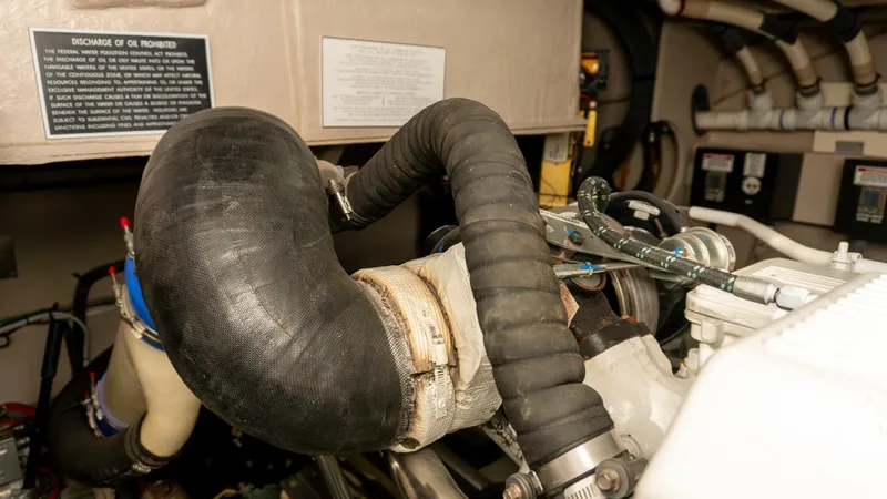 O-sea-d Yacht Photos Pics Engine compartment of 2017 Sea Ray 51 Flybridge, featuring hoses and mechanical components.