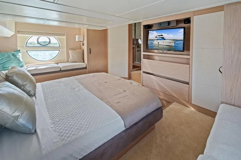  Yacht Photos Pics Luxurious bedroom interior of 2018 Monte Carlo MC 35 yacht with modern decor and window view.
