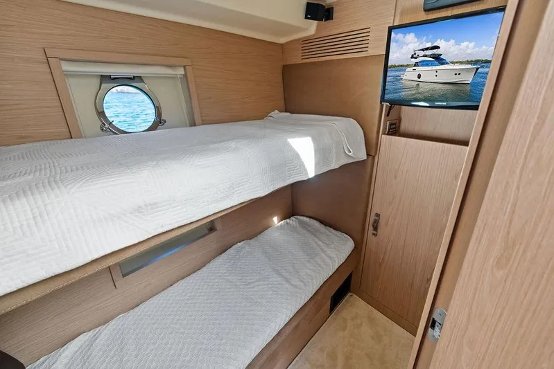  Yacht Photos Pics 2018 Monte Carlo MC 35 yacht cabin with bunk beds and porthole view.