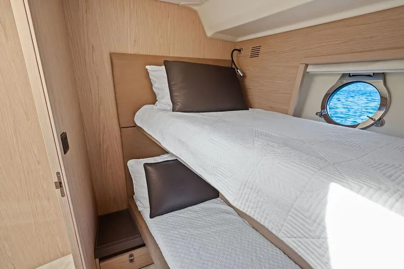  Yacht Photos Pics Interior cabin of 2018 Monte Carlo MC 35 yacht with bunk beds and porthole view.