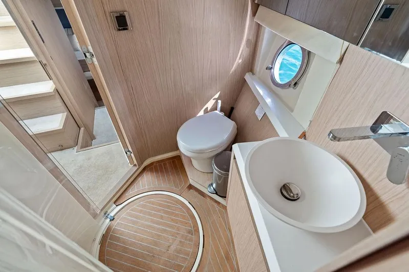  Yacht Photos Pics Luxurious 2018 Monte Carlo MC 35 yacht bathroom with modern fixtures and porthole view.