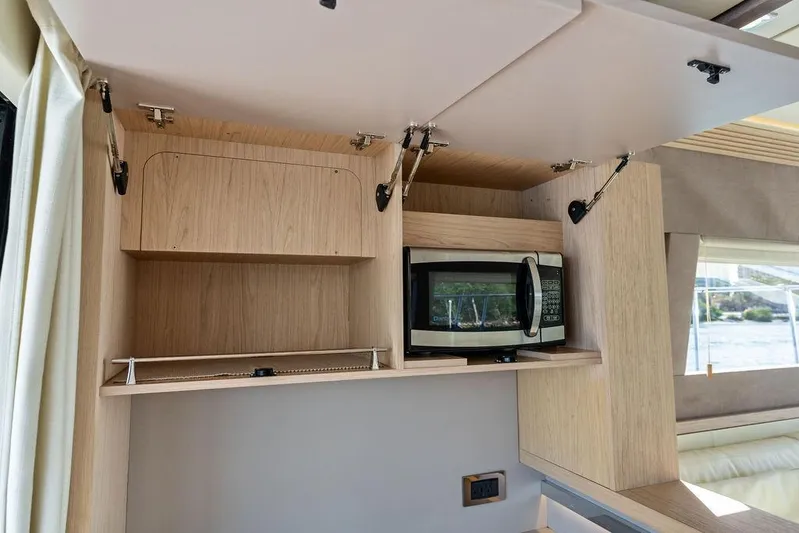  Yacht Photos Pics 2018 Monte Carlo MC 35 interior kitchen with microwave and open cabinets.