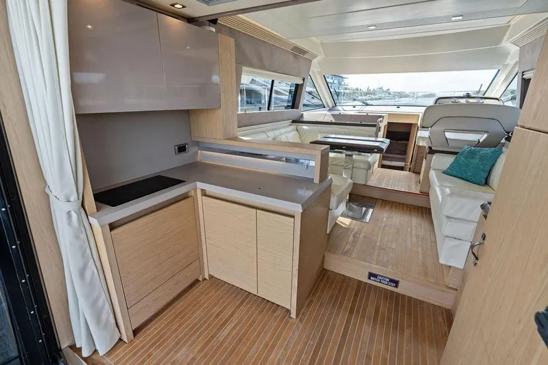  Yacht Photos Pics Luxurious interior of 2018 Monte Carlo MC 35 yacht with modern kitchen and seating area.