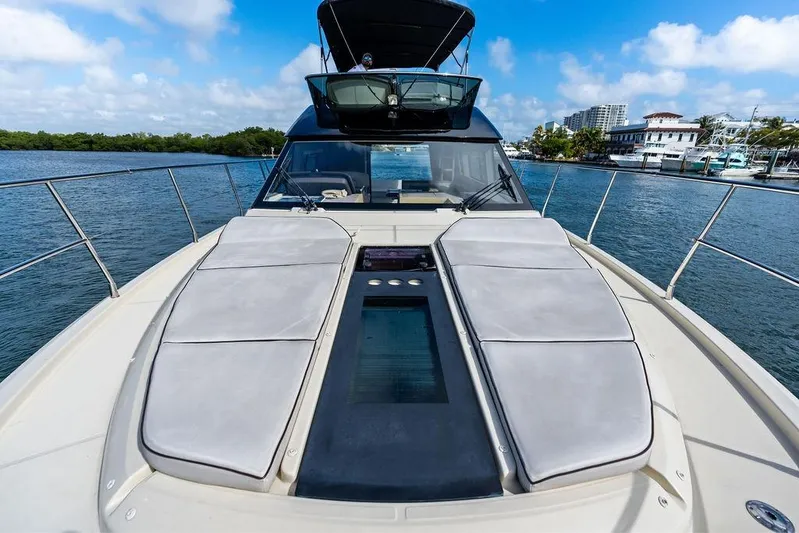  Yacht Photos Pics Luxurious 2018 Monte Carlo MC 35 yacht on serene water, featuring spacious sunbathing deck.
