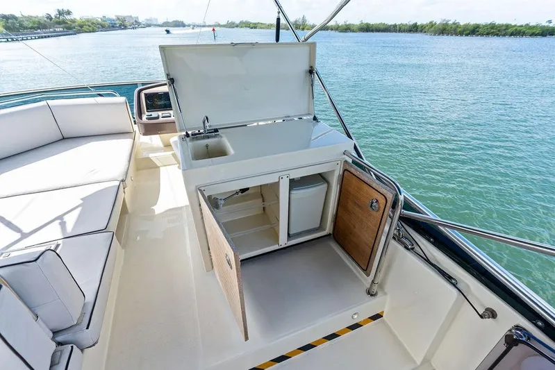  Yacht Photos Pics Luxurious Monte Carlo MC 35 yacht interior with kitchenette, 2018 model, overlooking serene waters.