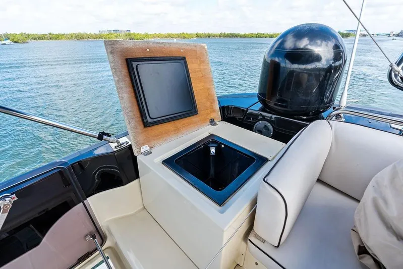  Yacht Photos Pics Luxury Monte Carlo MC 35 yacht interior with open storage compartment, 2018 model, on serene water.