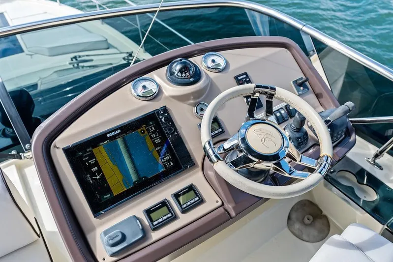  Yacht Photos Pics Cockpit of 2018 Monte Carlo MC 35 yacht with navigation system and steering wheel.