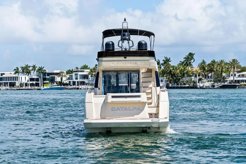  Yacht Photos Pics 2018 Monte Carlo MC 35 yacht cruising near luxury waterfront homes.