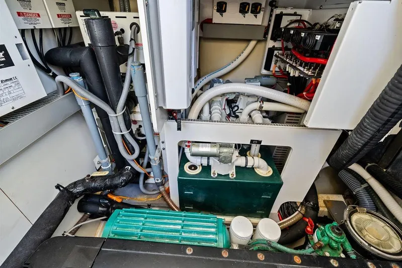  Yacht Photos Pics Engine room of a 2018 Monte Carlo MC 35 yacht, showcasing complex machinery and wiring.