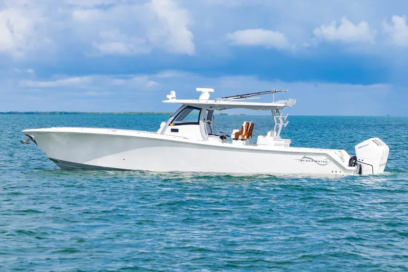 Big B Yacht Photos Pics 2024 Blackwater 43 Sportfish boat cruising on open water under a blue sky.