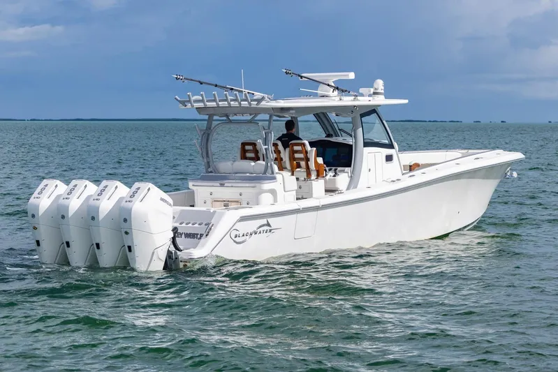 Big B Yacht Photos Pics 2024 Blackwater 43 Sportfish boat with four engines cruising on open water.