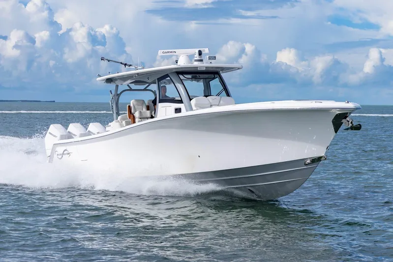 Big B Yacht Photos Pics 2024 Blackwater 43 Sportfish boat cruising on open water under a cloudy sky.