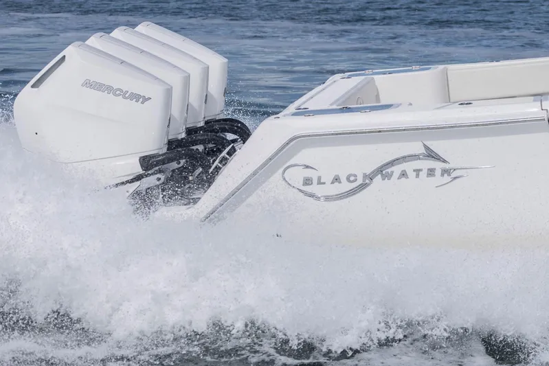 Big B Yacht Photos Pics 2024 Blackwater 43 Sportfish boat with Mercury engines, cutting through ocean waves.