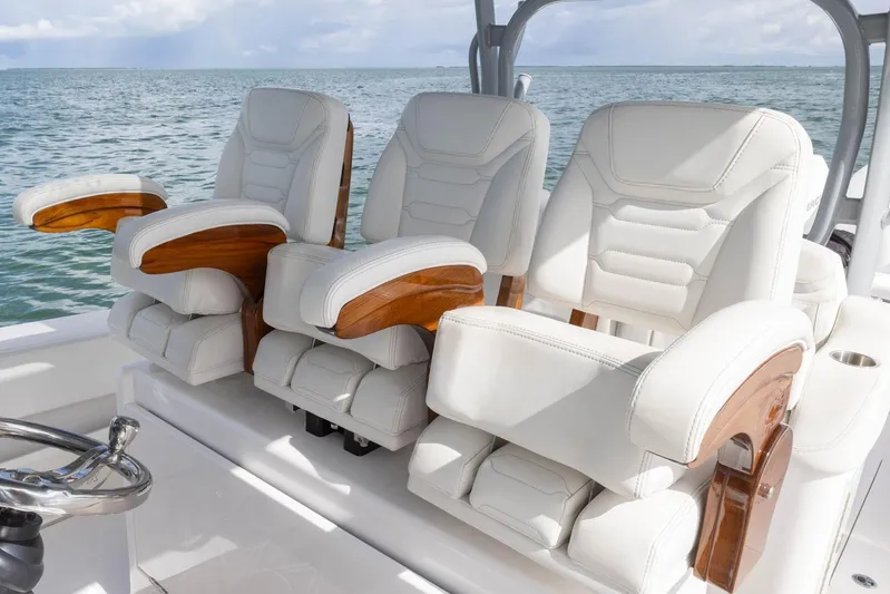 Big B Yacht Photos Pics Luxurious seating on 2024 Blackwater 43 Sportfish boat, featuring white leather and wooden accents.