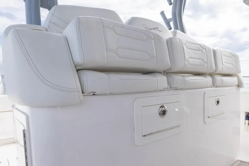 Big B Yacht Photos Pics 2024 Blackwater 43 Sportfish boat seating with white upholstery and storage compartments.