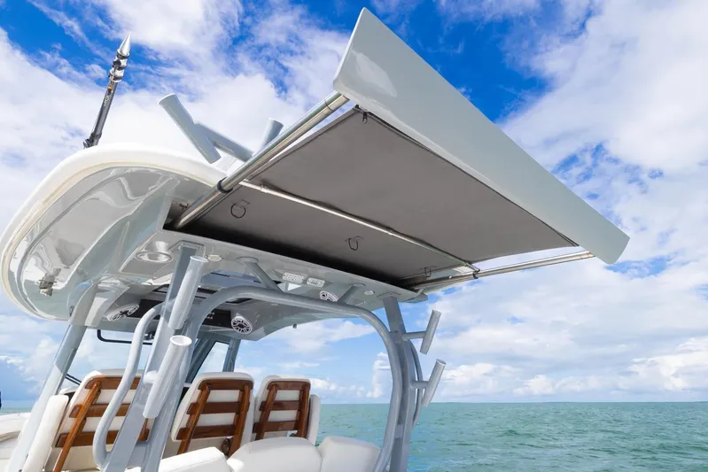 Big B Yacht Photos Pics 2024 Blackwater 43 Sportfish boat with canopy, ocean view, and blue sky background.