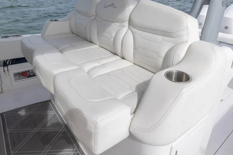 Big B Yacht Photos Pics Luxurious seating on 2024 Blackwater 43 Sportfish boat with white upholstery and cup holder.