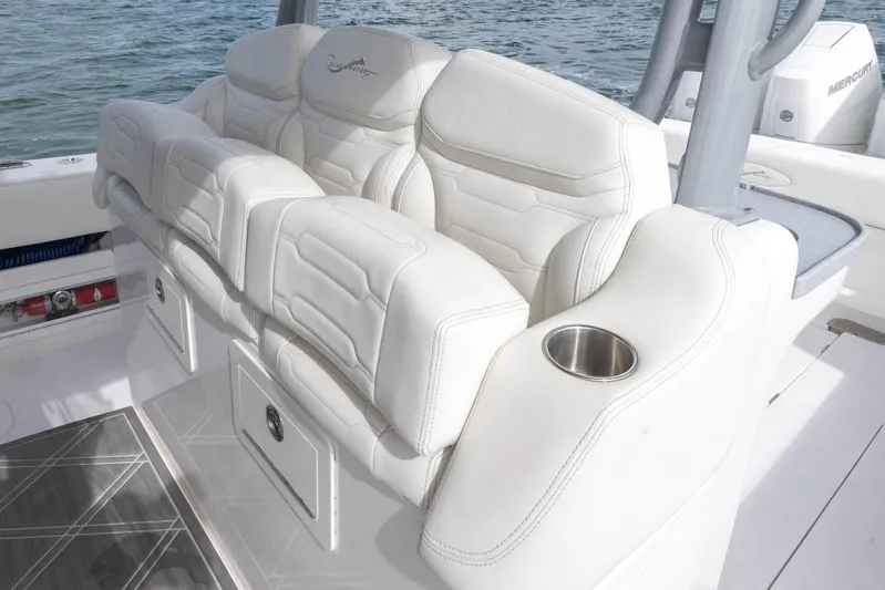 Big B Yacht Photos Pics Luxurious seating on 2024 Blackwater 43 Sportfish boat with cup holder, white upholstery.