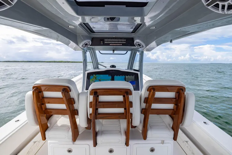 Big B Yacht Photos Pics 2024 Blackwater 43 Sportfish boat interior with wooden seats, navigating open waters.