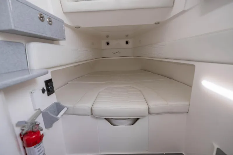 Big B Yacht Photos Pics 2024 Blackwater 43 Sportfish cabin interior with white cushioned seating and storage.