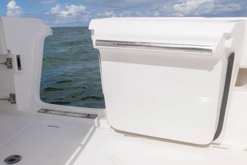 Big B Yacht Photos Pics 2024 Blackwater 43 Sportfish boat with open side door, ocean view.