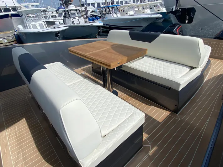  Yacht Photos Pics 2024 Solaris Power 40F Open yacht with elegant seating and wooden table on deck.