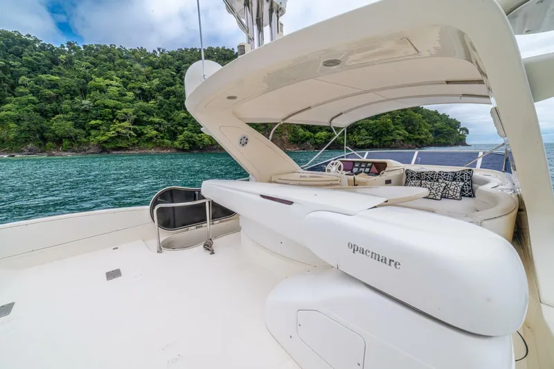 Hakuna Matata Yacht Photos Pics Luxurious 2007 Azimut 55 yacht deck with scenic ocean and lush island backdrop.
