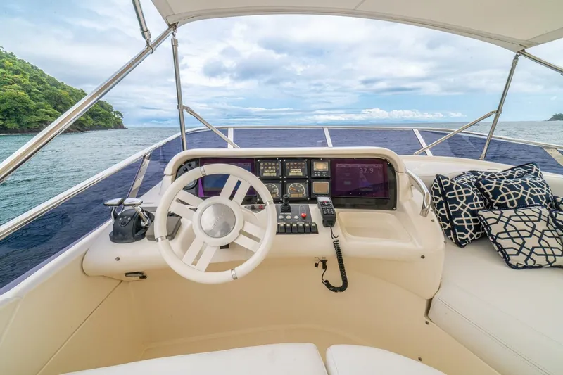 Hakuna Matata Yacht Photos Pics Helm of 2007 Azimut 55 yacht with ocean view and patterned cushions.