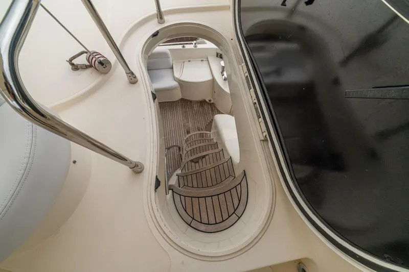 Hakuna Matata Yacht Photos Pics Staircase leading to lower deck on 2007 Azimut 55 yacht, featuring wooden steps and sleek design.