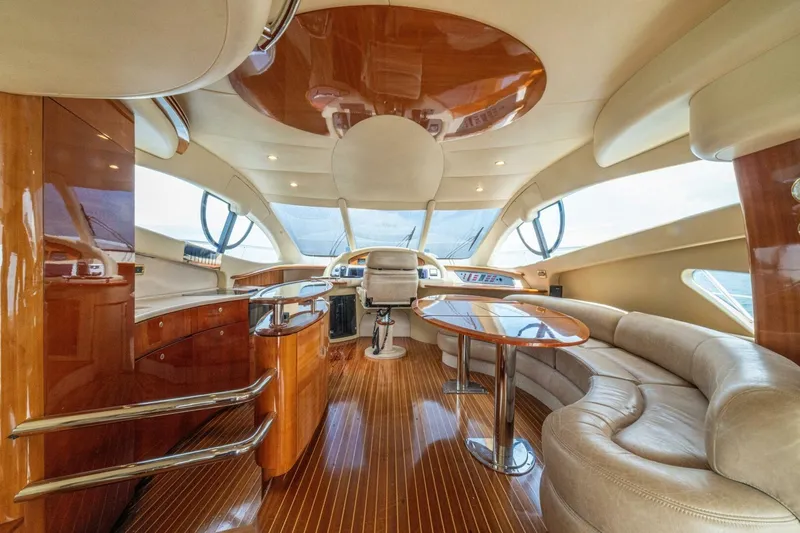 Hakuna Matata Yacht Photos Pics Luxurious interior of a 2007 Azimut 55 yacht with elegant wood finishes and plush seating.
