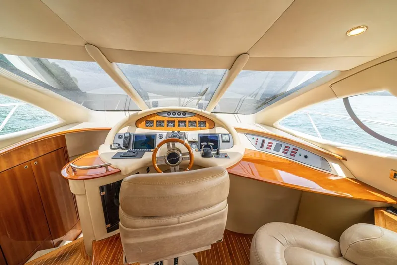 Hakuna Matata Yacht Photos Pics Luxurious helm of 2007 Azimut 55 yacht with modern navigation controls and leather seating.