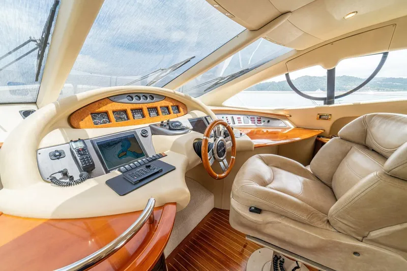 Hakuna Matata Yacht Photos Pics Luxurious 2007 Azimut 55 yacht cockpit with leather seating and advanced navigation controls.