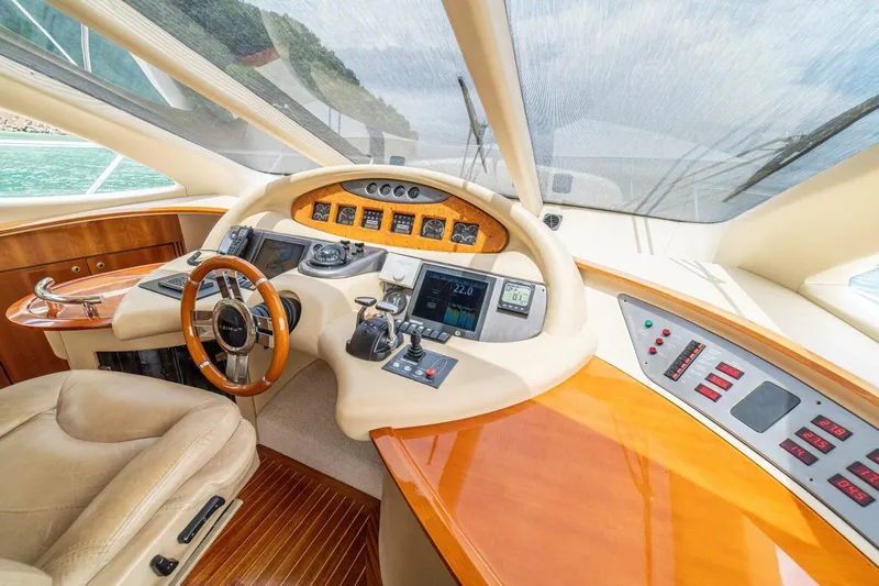 Hakuna Matata Yacht Photos Pics Luxurious helm of a 2007 Azimut 55 yacht with modern controls and leather seating.