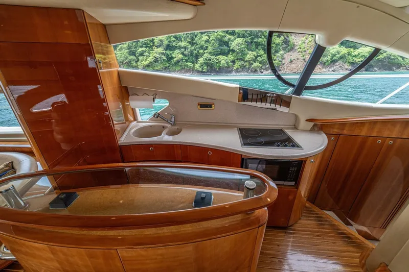 Hakuna Matata Yacht Photos Pics Luxurious 2007 Azimut 55 yacht interior with modern kitchen and scenic ocean view.