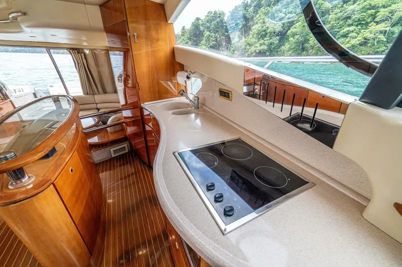 Hakuna Matata Yacht Photos Pics Luxurious interior of 2007 Azimut 55 yacht with modern kitchen and scenic view.