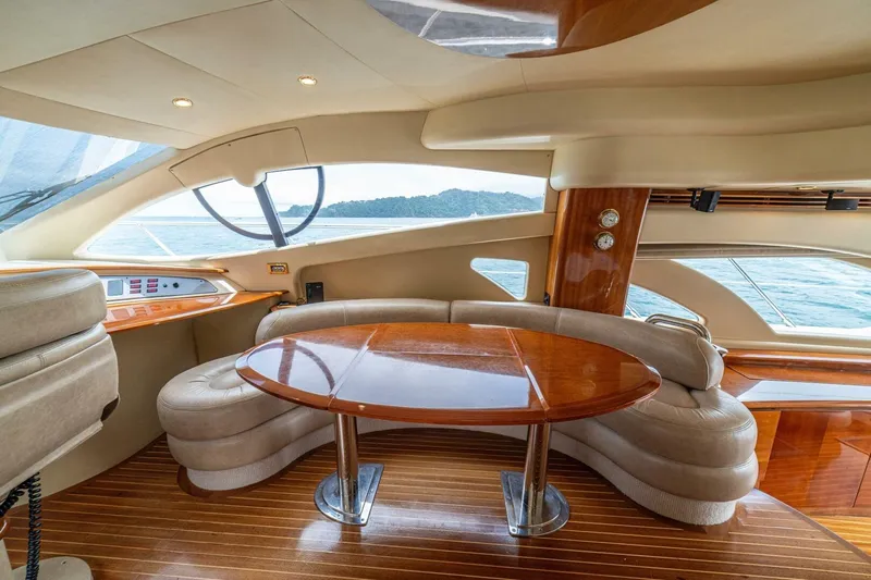 Hakuna Matata Yacht Photos Pics Luxurious interior of a 2007 Azimut 55 yacht with elegant wood finishes and plush seating.