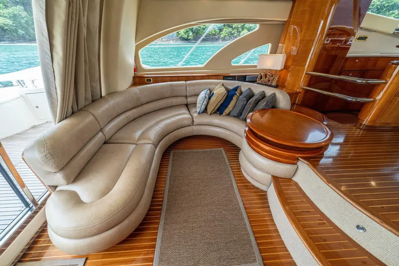 Hakuna Matata Yacht Photos Pics Luxurious interior of 2007 Azimut 55 yacht with curved leather seating and wooden accents.