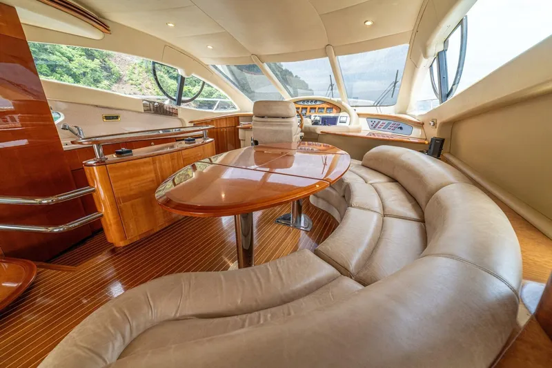 Hakuna Matata Yacht Photos Pics Luxurious interior of a 2007 Azimut 55 yacht with elegant seating and polished wood finishes.