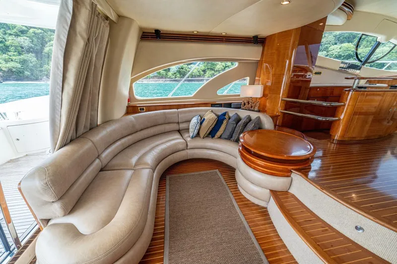 Hakuna Matata Yacht Photos Pics Luxurious interior of 2007 Azimut 55 yacht with curved leather seating and wooden accents.