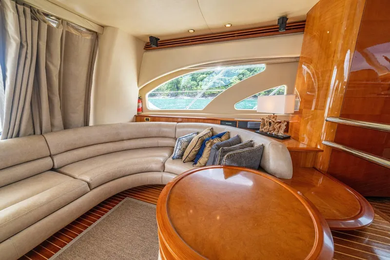 Hakuna Matata Yacht Photos Pics Luxurious interior of 2007 Azimut 55 yacht with curved sofa and elegant decor.