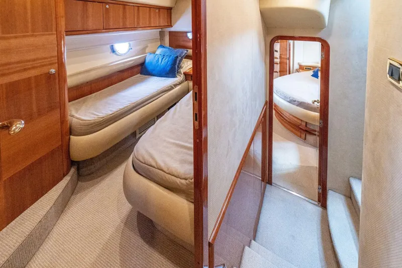 Hakuna Matata Yacht Photos Pics Luxurious interior of 2007 Azimut 55 yacht featuring cozy twin beds and elegant wood finishes.