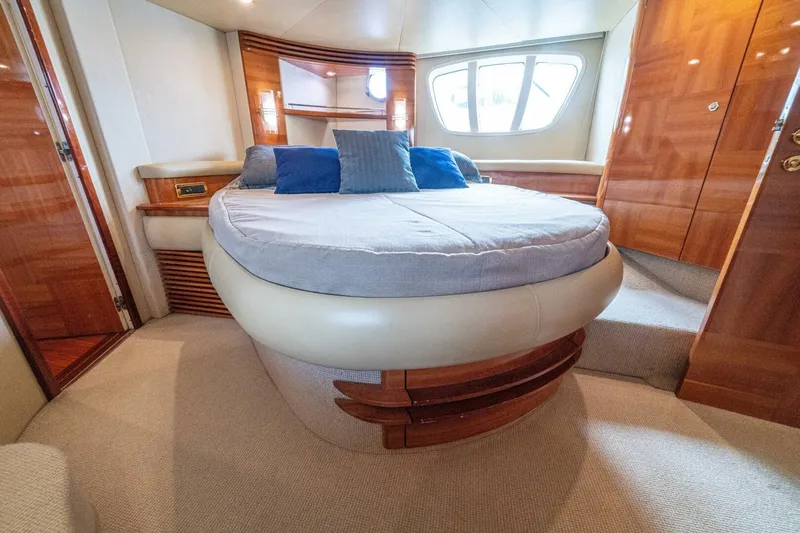 Hakuna Matata Yacht Photos Pics Luxurious bedroom interior of 2007 Azimut 55 yacht with elegant wood finishes.