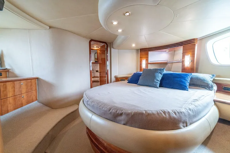 Hakuna Matata Yacht Photos Pics Luxurious bedroom interior of a 2007 Azimut 55 yacht with elegant furnishings.