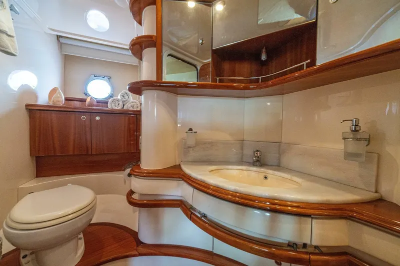 Hakuna Matata Yacht Photos Pics Luxurious bathroom interior of 2007 Azimut 55 yacht with elegant wood finishes.