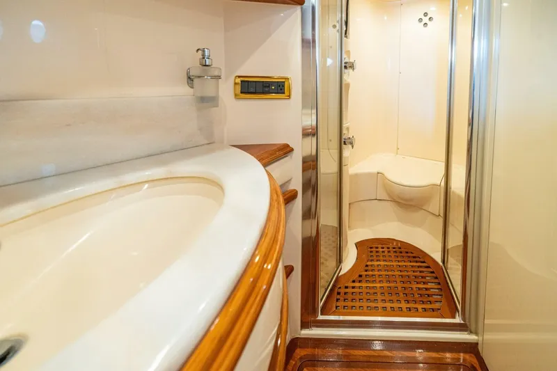 Hakuna Matata Yacht Photos Pics Luxurious bathroom interior of 2007 Azimut 55 yacht with elegant wood accents.