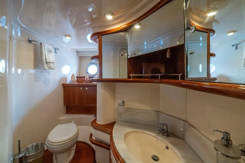 Hakuna Matata Yacht Photos Pics Luxurious bathroom in a 2007 Azimut 55 yacht, featuring elegant wood accents and modern fixtures.