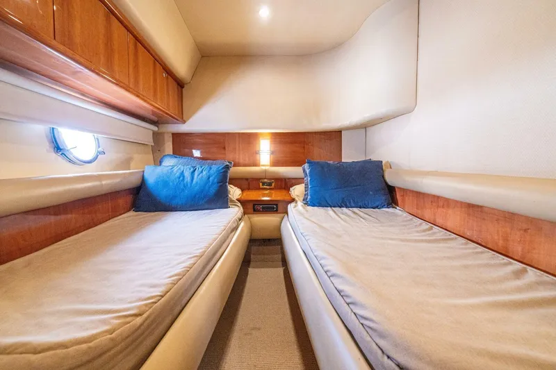 Hakuna Matata Yacht Photos Pics Luxurious 2007 Azimut 55 yacht cabin with twin beds and blue pillows.